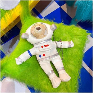 Detail view of astronaut cross-body bag with clear PVC window and plush teddy bear