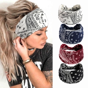 Detail of four paisley printed elastic headbands in white, navy, burgundy and black