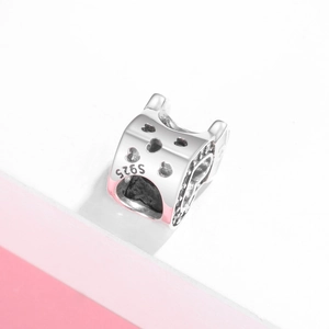Macro shot of S925 sterling silver heart charm with pink enamel and cubic zirconia details