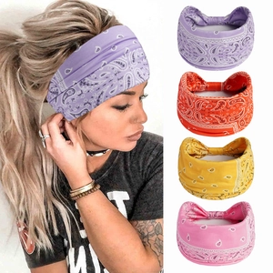 Close-up of bohemian paisley print wide headbands in purple, orange, yellow, and pink colors