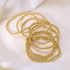7-piece stackable 18K gold beaded elastic bracelet set with polished round beads