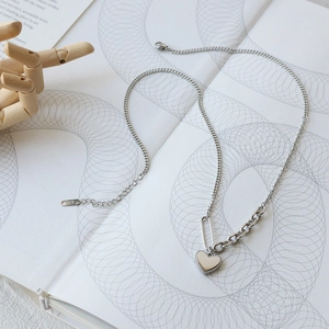Detail of silver heart pendant necklace with mixed link chains and K18 engraving