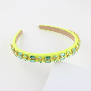 Detailed side view of baroque headband featuring green rhinestones on neon fabric