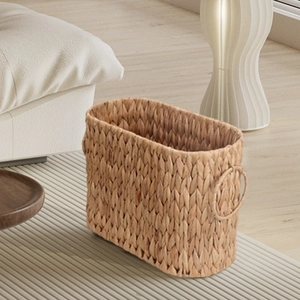 Macro view of woven seagrass basket showing detailed texture and sturdy metal ring handles