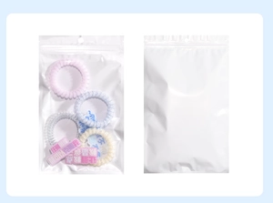 Detail of translucent resealable bags showing four colorful spiral hair ties and charms