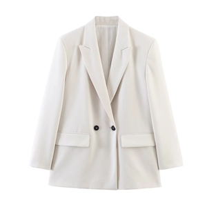 Detail of elegant peak lapel and dark contrast buttons on beige women blazer