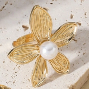 French vintage gold flower ring with pearl on natural stone background, open design