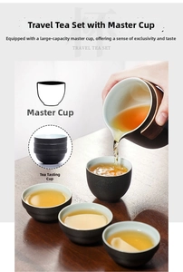 Detail of pouring golden tea from a matte black travel pot with wooden heat-insulation