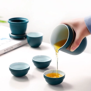 Portable ceramic travel tea set with teapot, four cups and filter in dark teal matte finish