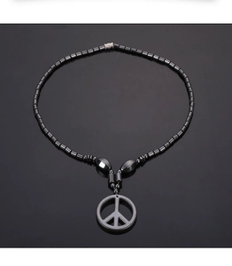 Detailansicht des Peace-Zeichen-Anhängers an einer schwarzen Magnet-Hämatit-Perlenkette