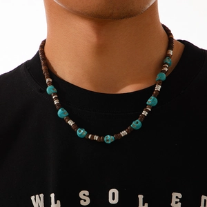 Close-up of hip-hop men's necklace with brown beads and turquoise skull details