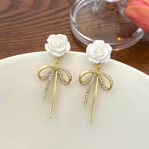 French vintage long tassel earrings featuring white resin roses and golden crystal bows