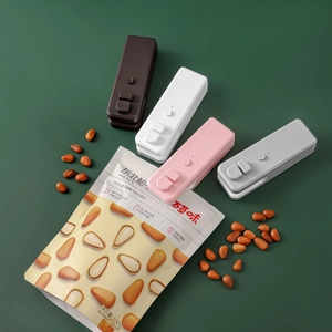Handheld portable bag sealer in four colors placed next to food packaging for home kitchen use