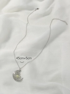 Close-up of hollow moon pendant with luminous bead on 45cm plus 5cm silver chain