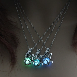 Luminous mermaid locket necklaces glowing in green and blue colors for Halloween