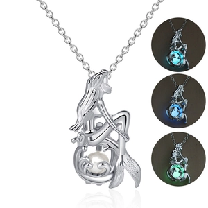 Silver mermaid necklace with luminous pearls glowing in blue and green in the dark