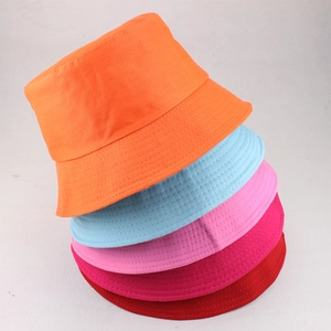 Detailed close-up of colorful polyester bucket hats stacked in five vibrant color options