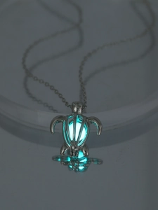 Glow-in-the-dark turtle pendant with luminous blue bead and hollow metal shell detail