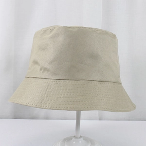Detailed view of beige polyester bucket hat with reinforced brim stitching and twill weave