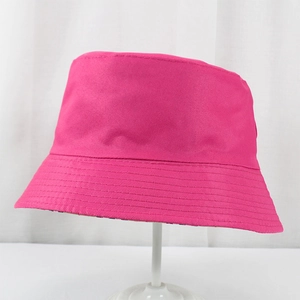 Detail of rose red canvas bucket hat with sturdy stitching and reversible pattern design