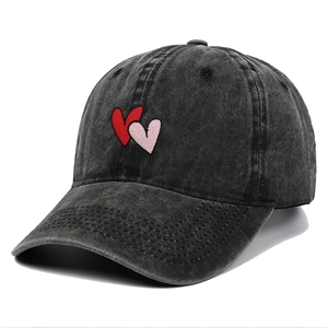 Washed dark grey baseball cap with embroidered overlapping red hearts on cotton denim