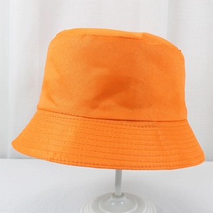 Detailed view of the orange polyester bucket hat with reinforced brim stitching on a stand