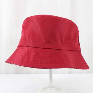 Close-up of deep red polyester sun bucket hat with reinforced stitching and plaid lining