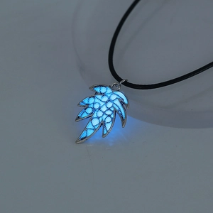 Luminous blue leaf pendant necklace glowing in dark with silver frame and black cord