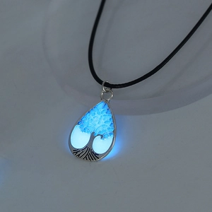 Luminous water drop pendant with tree of life design and blue glow on black cord