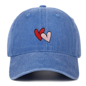 Close-up of double heart embroidery on vintage washed navy blue cotton baseball cap