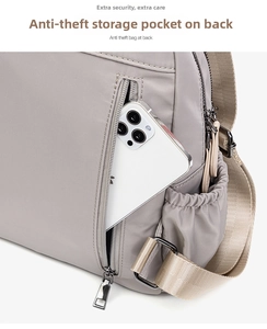 Detail shot of a grey nylon backpack featuring a functional anti-theft back zipper pocket