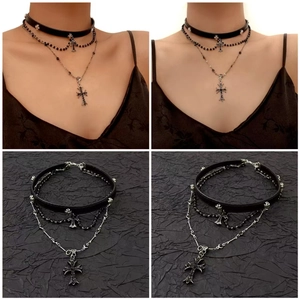 Detail of gothic multi-layer necklace with leather choker and black cross pendants