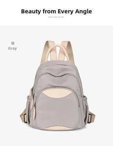 Front view of a gray nylon backpack with beige straps and multi-pocket functional design