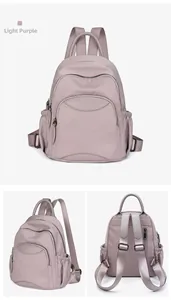 Detail view of light purple nylon backpack showing front zip pocket and side mesh pocket