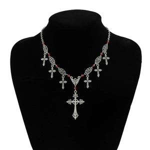 Gothic silver cross necklace with red crystal beads on a black neck mannequin
