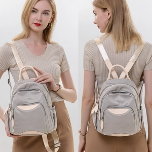 Gray oxford fabric backpack for women with beige leather accents and multiple pockets