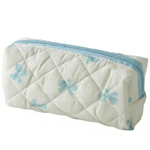Pochette de rangement blanche matelassée avec nœuds bleus et fermeture éclair