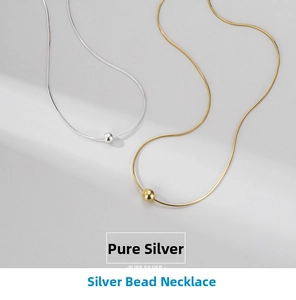 Close-up of minimalist S925 sterling silver bead necklace in gold and silver finish