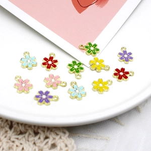 Close-up of colorful enamel flower charms for DIY jewelry making and craft accessories