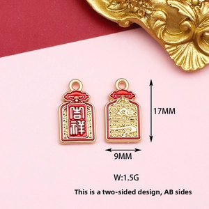 Detail of double-sided gold-plated alloy pendant with lucky characters and clouds