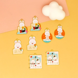 Detailed view of colorful graduation rabbit enamel charms for DIY jewelry and keychains