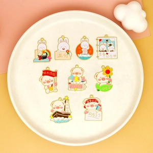 Macro view of cute pig and rabbit alloy enamel charms for graduation and exam good luck