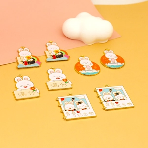 Selection of various cute enamel bunny charms with motivational Chinese characters for gifts