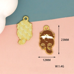 Close-up detail of cute cartoon otter enamel charm showing dimensions 23mm x 12mm and weight