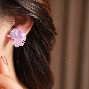 Detailed view of sweet purple resin flower beaded non-pierced ear clips worn on model