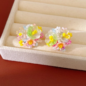 Macro detail of colorful resin flower beaded clip-on earrings for non-pierced ears