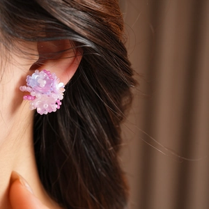 Detailed view of colorful resin flower beaded earring worn on ear, sweet and elegant style.