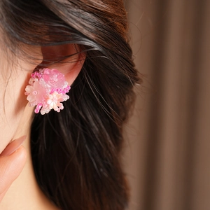 Close-up of pink resin flower beaded clip-on earrings on ear, sweet style