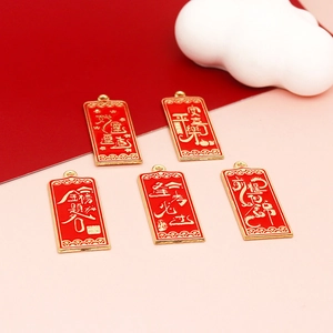 Detailed view of red alloy pendants with gold Chinese blessing characters for good luck