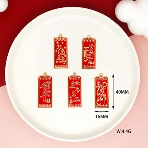 Macro detail of red enamel charm pendants with gold Chinese characters and dimensions.